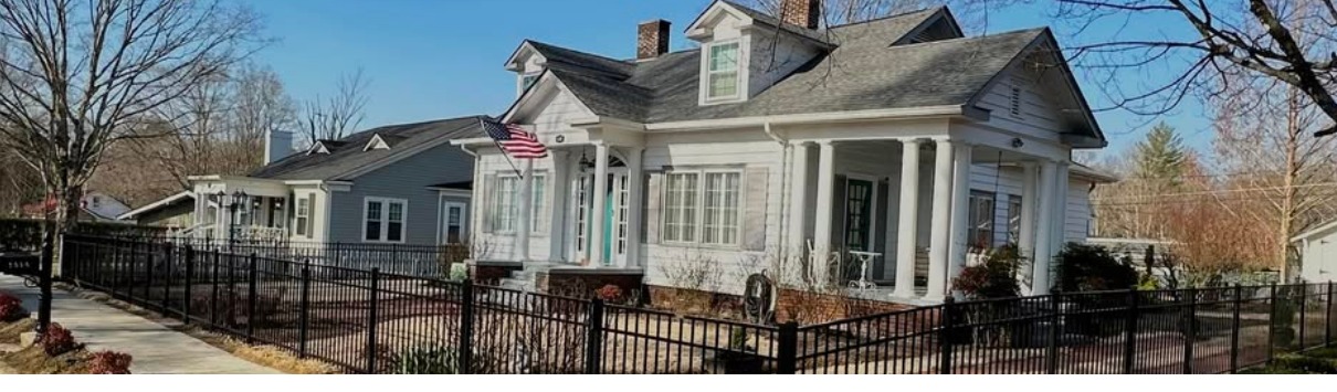 Black ornamental metal fence in front of a home in Athens, TN, built by Athens Fence Company
