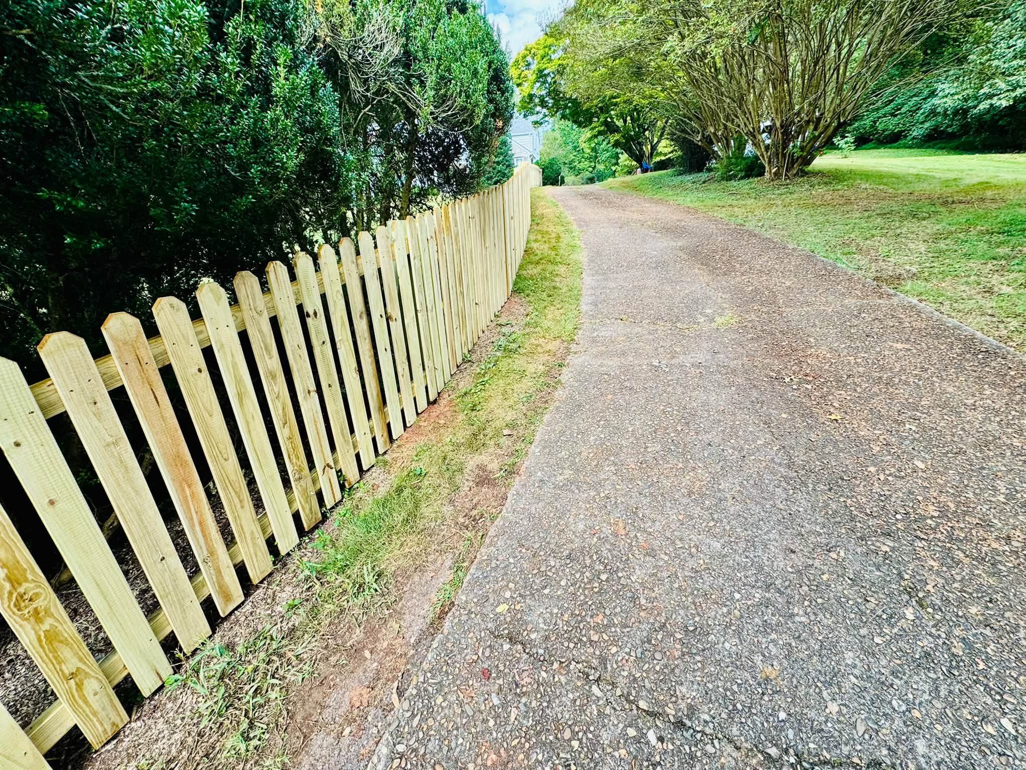 New wood picket fence along a driveway in Athens, TN