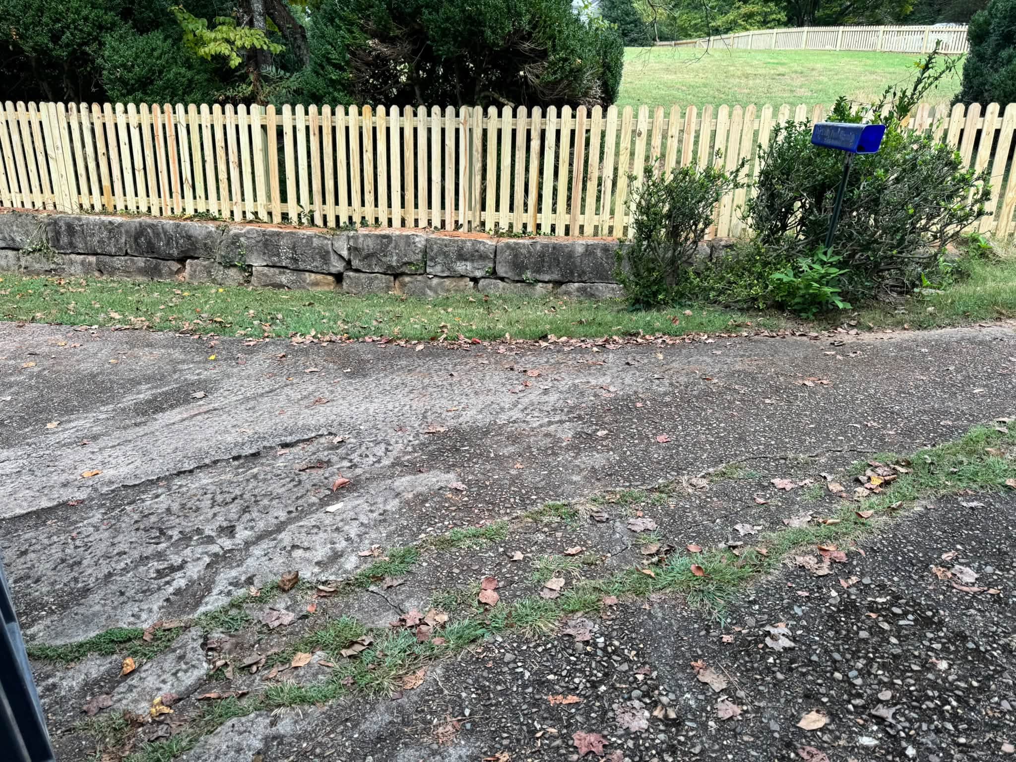 Wood picket fence set on a stone wall in Athens, TN