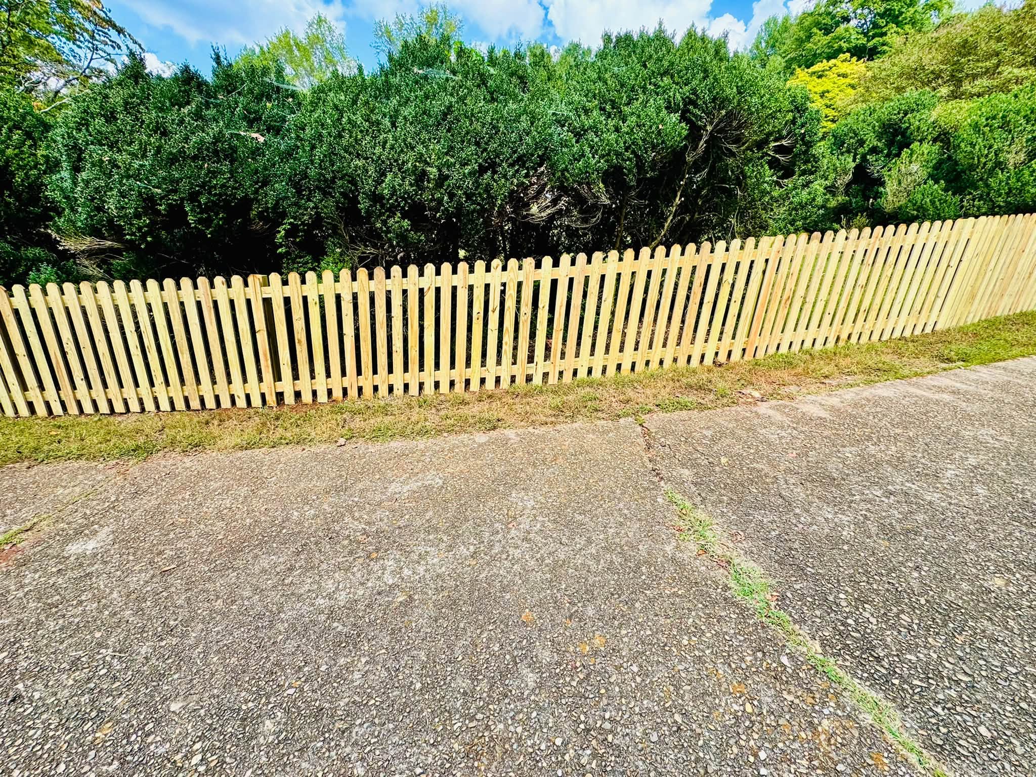 Long run of new wood picket fence built by Athens Fence Company in Athens, TN